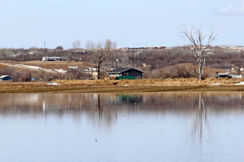 Ian Froese/The Brandon Sun
Water from the Assiniboine River approaches a Sioux Valley Dakota Nation home that has a dike surrounding the property on Monday.