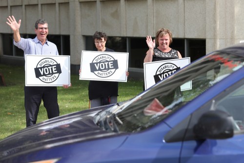 Brandon West Progressive Conservative candidate Reg Helwer, left, waves as he and other supporters of Disability Matters Vote, a non-partisan advocacy group, hold a rally on 18th Street and Victoria Avenue earlier this month. (File)