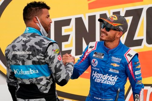 FILE - Bubba Wallace, left, congratulates Kyle Larson after Larson won a NASCAR Cup Series auto race in Las Vegas, in this Sunday, March 7, 2021, file photo. Rick Hendrick gave Kyle Larson a second chance in NASCAR because Hendrick Motorsports had wanted him in its lineup for years. Now that Hendrick has his man, he's locked Larson down for two more seasons with full sponsorship. Hendrick on Wednesday, July 14, told his 93 dealerships that the hottest driver in motorsports signed a contract extension through 2023 and Larson will be fully sponsored by HendrickCars.com. (AP Photo/John Locher, File)