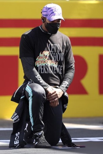 Mercedes driver Lewis Hamilton of Britain takes the knee on the grid before the British Formula One Grand Prix, at the Silverstone circuit, in Silverstone, England, Sunday, July 18, 2021. (Lars Baron/Pool photo via AP)