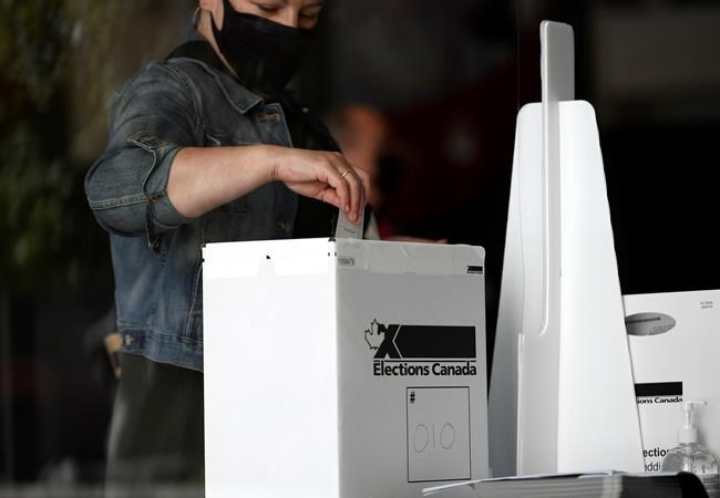 A voter casts their ballot at a polling location on election day during the 44th Canadian general election, on Monday, Sept. 20, 2021. Canadians may not be thrilled with the outcome of last week's federal election but a new poll suggests few are angry that it produced an almost identical result to the 2019 nation-wide vote. THE CANADIAN PRESS/Justin Tang