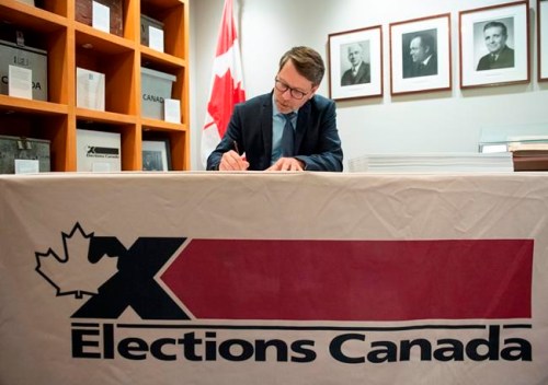 Chief Electoral Officer Stephane Perrault signs the writs of the 43rd general election during a photo opportunity in Gatineau, Que., on Friday, Sept. 20, 2019. Elections Canada is confirming that a recount will take place in Quebec riding with a close result after a 