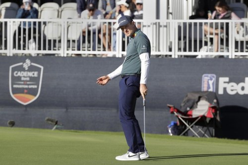 Justin Rose reacts as he watches his putt miss the cup on the 18th green during the third round of the Houston Open golf tournament, Saturday, Nov. 12, 2022, in Houston. (AP Photo/Michael Wyke)