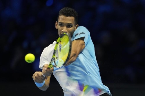 Canada's Felix Auger-Aliassime returns the ball to United States' Taylor Fritz during their singles tennis match of the ATP World Tour Finals, at the Pala Alpitour in Turin, Italy, Thursday, Nov. 17, 2022. Auger-Aliassime dropped a 7-6 (4), 6-7 (5), 6-2 decision to Fritz on Thursday at the ATP Finals. THE CANADIAN PRESS/AP-Antonio Calanni