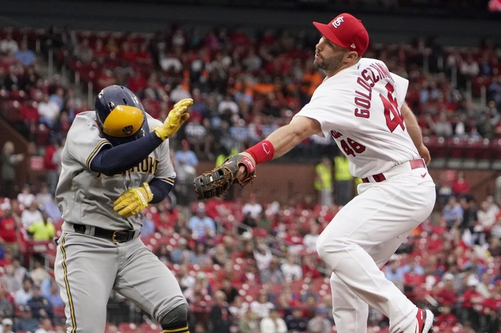 FILE - Milwaukee Brewers' Luis Urias, left, is safe at first as he avoids the tag from St. Louis Cardinals first baseman Paul Goldschmidt during the second inning of a baseball game May 26, 2022, in St. Louis. Cardinals shortstop Edmundo Sosa was charged with a throwing error on the play. Goldschmidt won the National League MVP award Thursday night, Nov. 17, taking the coveted trophy for the first time after a couple of close calls earlier in his career. The first baseman received 22 of 30 first-place votes and eight seconds for 380 points from a Baseball Writers’ Association of America panel. (AP Photo/Jeff Roberson, File)