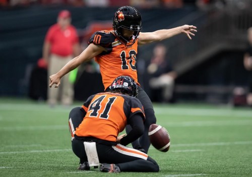 B.C. Lions' Sean Whyte (10) kicks a field goal as Stefan Flintoft holds during the first half of CFL football game against the Hamilton Tiger-Cats in Vancouver, on Thursday, July 21, 2022. The Lions have signed placekicker Whyte to a one-year extension.THE CANADIAN PRESS/Darryl Dyck