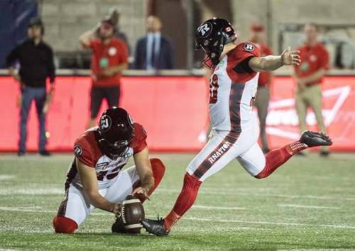 Ottawa Redblacks' Lewis Ward, right, kicks a field goal during second half CFL football action against the Montreal Alouettes in Montreal, Friday, Sept. 2, 2022. The Ottawa Redblacks have signed Ward to a two-year contract. THE CANADIAN PRESS/Graham Hughes