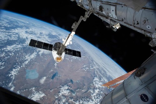 The Canadarm 2 reaches out to capture the SpaceX Dragon cargo spacecraft and prepare it to be pulled into its port on the International Space Station, Friday, April 17, 2015. THE CANADIAN PRESS/AP/NASA