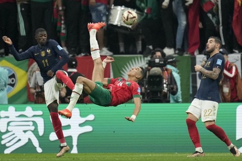 Morocco's Jawad El Yamiq, center, attempts a shot at goal during the World Cup semifinal soccer match between France and Morocco at the Al Bayt Stadium in Al Khor, Qatar, Wednesday, Dec. 14, 2022. (AP Photo/Christophe Ena)