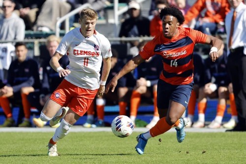 Clemson's Brandon Parrish (11) battles Syracuse's Levonte Johnson (14) for control of the ball during the first half of the Atlantic Coast Conference Men's Soccer Tournament championship match in Cary, N.C., Sunday, Nov. 13, 2022. Canadian forward Johnson, who helped Syracuse to the NCAA College Cup on Monday, is one of three finalists for the 2022 MAC Hermann Trophy. THE CANADIAN PRESS/AP Photo/Karl B DeBlaker