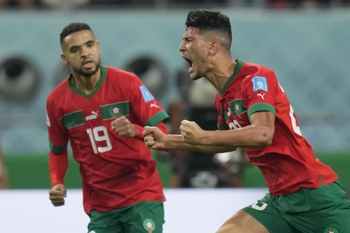 Morocco's Achraf Dari, right, celebrates after scoring his side's first goal during the World Cup third-place playoff soccer match between Croatia and Morocco at Khalifa International Stadium in Doha, Qatar, Saturday, Dec. 17, 2022. (AP Photo/Francisco Seco)