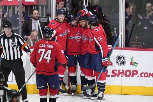 CORRECTS TO SECOND PERIOD NOT FIRST - Washington Capitals defenseman Erik Gustafsson, center, celebrates with defenseman John Carlson (74), right wing Anthony Mantha, center Evgeny Kuznetsov (92), and left wing Sonny Milano (15) after scoring against the Toronto Maple Leafs during the second period of an NHL hockey game, Saturday, Dec. 17, 2022, in Washington. (AP Photo/Jess Rapfogel)