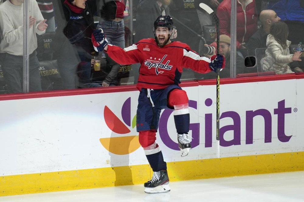 Washington Capitals defenseman Erik Gustafsson (56) celebrates after scoring a hat trick against the Toronto Maple Leafs during the third period of an NHL hockey game, Saturday, Dec. 17, 2022, in Washington. The Capitals won 5-2. (AP Photo/Jess Rapfogel)