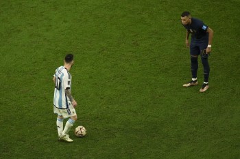 France's Kylian Mbappe, right, watches Argentina's Lionel Messi, left, during the World Cup final soccer match between Argentina and France at the Lusail Stadium in Lusail, Qatar, Sunday, Dec. 18, 2022. (AP Photo/Francisco Seco)