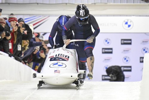 Kaillie Humphries and Kaysha Love of The United States, during the start of the women's bobsled World Cup race on Sunday, Dec. 18, 2022, in Lake Placid, N.Y. (AP Photo/Hans Pennink)