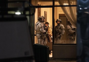 York Regional Police tactical officers are seen in the lobby of a condo building in Vaughan, Ont., Sunday, Dec. 18, 2022. Police say multiple people are dead, including the suspect, after a shooting in an apartment building. THE CANADIAN PRESS/Arlyn McAdorey