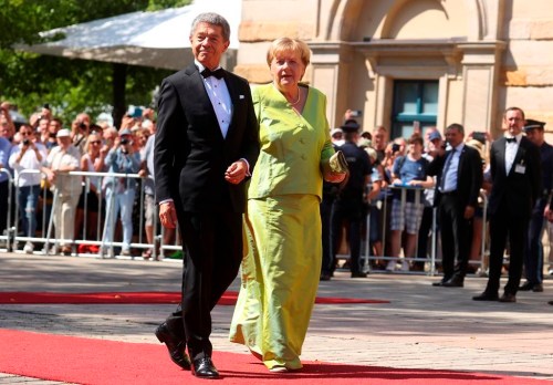 FILE - Angela Merkel, former German Chancellor, and husband Joachim Sauer arrive for the opening of the Bayreuth Richard Wagner Festival at the Festspielhaus on the Gruener Huegel in Bayreuth, Germany, July 25, 2022. Former German Chancellor Angela Merkel, a longtime opera buff, is offering her thoughts on Richard Wagner's Ring cycle in a new podcast, the latest in a series of sporadic appearances since she left office a year ago. (Karl-Josef Hildenbrand/dpa via AP, File)