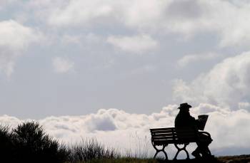 A man reads a newspaper on a sunny morning at Ogden Point in Victoria, B.C. A report on the Canadian Association for Mental Health website says 