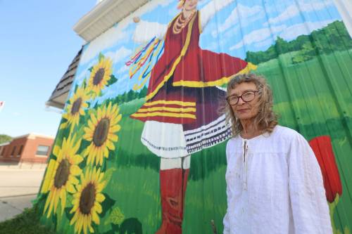 Mary Lowe stands in front of the Zion Pentecostal Church in Rivers. She and her daughter Mary are teaming up to cover the side of the building, which used to be a centre serving Ukrainian dance and language lessons. (Connor McDowell/Brandon Sun)