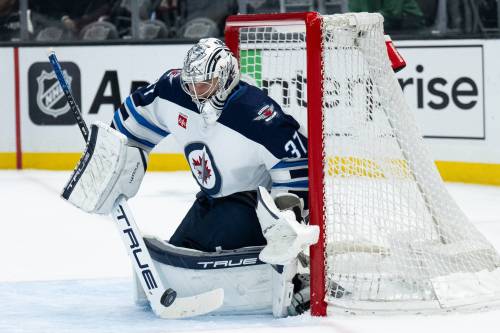 Winnipeg Jets goaltender Connor Hellebuyck (37) blocks a shot during the second period of an NHL hockey game against the Los Angeles Kings on April 1. The Jets have secured their playoff spot, but for other NHL teams it will be a wild finish to the regular season, Bruce Penton writes. (The Associated Press)