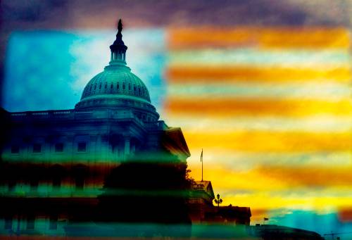 The U.S. Capitol dome is viewed through a reflection of the American flag on Capitol Hill. (Melina Mara/Washington Post files)
