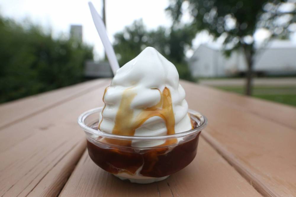 LEFT: A small caramel sundae from Ninette’s Hot ‘N’ Frosty drive-in begins to melt on a warm summer Tuesday afternoon. RIGHT: Hot ‘N’ Frosty drive-in offers customers a wide assortment of sides and snacks on their menu, including breaded pickles with ranch dressing.