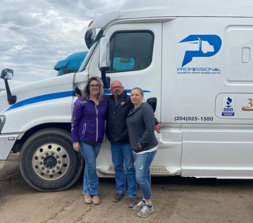 Nicole Miller (left) poses for a picture with Professional Transport Driver Training School general manager Ryan Kyle and another truck driver on her graduation day from the training school. (Submitted)