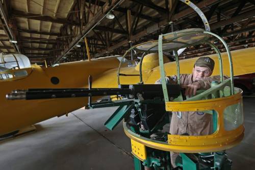 Chief pilot at the Commonwealth Air Training Plan Museum, Jeff Bell, holds an antique Bolingbroke Turrent. The machine guns were mounted on some RCAF aircraft, as seen on the left side of the screen, in the Second World War era. (Connor McDowell/The Brandon Sun)