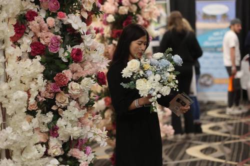 Sheryl Stodomingo of Weddings by Abby checks out a Westman Wedding Expo schedule during the 2024 event. This year&rsquo;s expo takes place at the Keystone Centre on Sunday. (The Brandon Sun files)