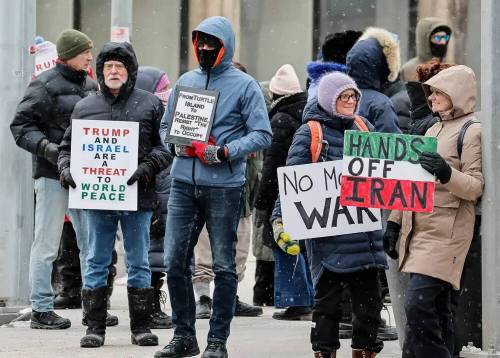 Protesters express their concerns over the U.S.-Israeli military strikes outside the U.S. Consulate on Portage Avenue on Sunday. (John Woods/Winnipeg Free Press)