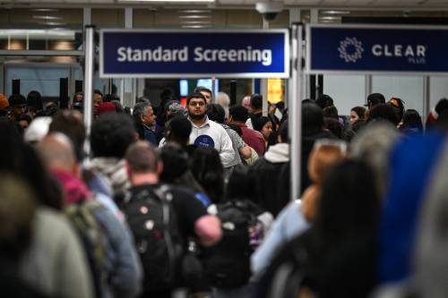 Travellers wait in line at a TSA security checkpoint at George Bush Intercontinental Airport in Houston on Friday. The dispute over funding for Homeland Security is putting pressure on screening at some of the largest U.S. airports. (Tribune News Service)