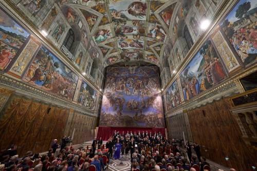 Conductor Harry Christopher (centre) with tenor Matthew McKinney (left) soprano Elizabeth Watts, (second from left) and The Sixteen present Angels Unawares byJames MacMillan in the Sistine Chapel at the Vatican on Sunday. The Vatican&rsquo;s Sistine Chapel hosted a concert, debuting a composition focused on interactions with angels found throughout the Bible. (The Associated Press)