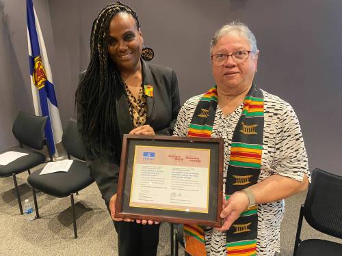 Andrea Davis (left) the executive director of the Black Loyalist Heritage Centre, and Sheila Hartley-Scott, president of the Black Loyalist Heritage Society&rsquo;s volunteer board are shown at the Nova Scotia Archives in Halifax on Saturday. (The Canadian Press)