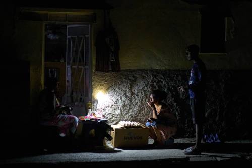 Street vendors chat during a blackout in Havana, Cuba on March 16. (The Associated Press)