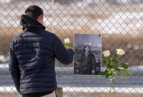 A man places a white rose on the memorial for Air Canada Jazz pilot Antoine Forest, who perished when his plane collided with an emergency vehicle at New York&rsquo;s LaGuardia Airport, in Montreal, on Wednesday. 
                                (The Canadian Press)