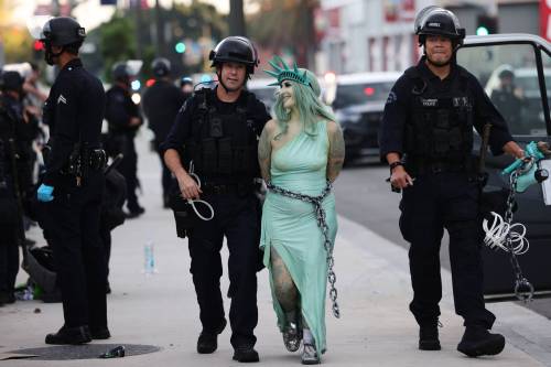Police arrest a protester dressed as the Statue of Liberty, in downtown Los Angeles after the &ldquo;No Kings&rdquo; rally on Saturday. (The Associated Press)