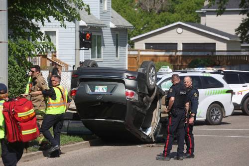 Brandon Fire and Emergency Services members and Brandon Police Service members respond to a two-vehicle collision that caused one of the vehicles to roll onto its roof at the corner of Victoria Avenue and Sixth Street in Brandon late Friday afternoon. Police said there were no serious injuries and the cause of the crash is still under investigation. Alcohol is not believed to have been a factor. (Tim Smith/The Brandon Sun)
