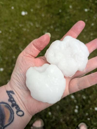 Susan Oakley holds two large hailstones that fell in Sanford on June 9. (Susan Oakley photo)