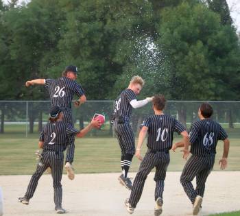 CASSIDY DANKOCHIK / THE CARILLON
                                Carillon Sultans right fielder Joe Plett is mobbed by teammates after driving home the championship-winning run in the MJBL final against the Elmwood Giants in Steinbach on Tuesday night.