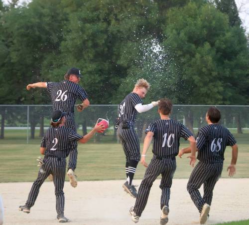 CASSIDY DANKOCHIK / THE CARILLON
                                Carillon Sultans right fielder Joe Plett is mobbed by teammates after driving home the championship-winning run in the MJBL final against the Elmwood Giants in Steinbach on Tuesday night.
