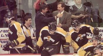 Mark Johnston (in the blue suit) hugs head coach Bobby Lowes after a series-clinching win in the playoffs. Johnston, who also served as an assistant coach, is being honoured for his work as a scout when he is inducted into the Professional Hockey Scouts Foundation&rsquo;s Wall of Honour on Aug. 28 in Okotoks, Alta. (Brandon Sun file)