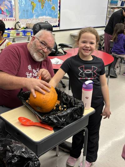 LEFT: Hands-on pumpkin carving is great fun for kids and seniors alike. RIGHT: Themed story time shared across generations with Brandon Seniors for Seniors. (Photos supplied)