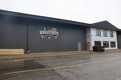 LEFT: The Wheat City Tennis and Pickleball Hub on Pacific Avenue. RIGHT: Schultz is seen in front of the entrance, which will lead to amenities in the centre portion of the facility. The area will open up onto asphalt courts where pickleball and tennis can be played. (Photos by Connor McDowell/The Brandon Sun)