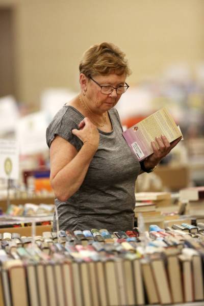 Volunteer Penny LaRocque sorts books ahead of the Rotary Fall Book Sale at the Victoria Inn Imperial Ballroom. The sale runs today, tomorrow and Saturday. (Matt Goerzen/The Brandon Sun files)