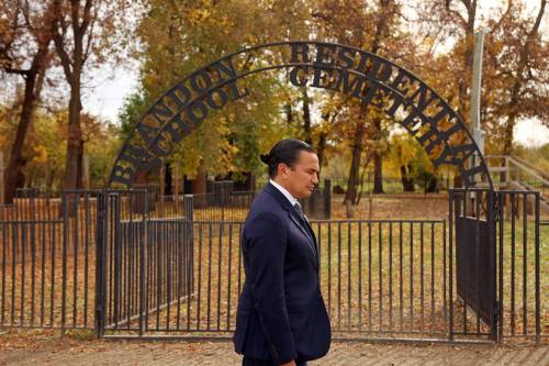Manitoba Premier Wab Kinew walks near the entrance of the Brandon Residential School Cemetery at the former Turtle Crossing Campground along Grand Valley Road last month after the province announced that it had purchased the former campground in partnership with the City of Brandon. 
                                (Tim Smith/The Brandon Sun files)